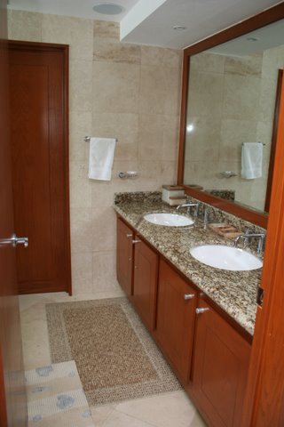 ultra luxury bathroom with sit down shower, granite conters, and fine porcelain tiles