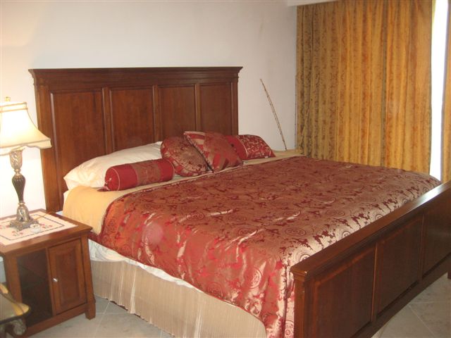 master bedroom with lagoon and city view terrace, full bath, walk in closet and 32 inch lcd tv