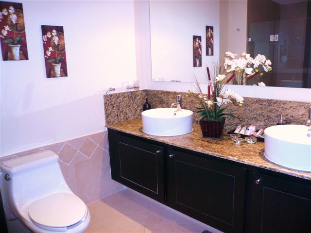 ultra luxury bathroom with sit down shower, granite towers, and fine porcelain tiles