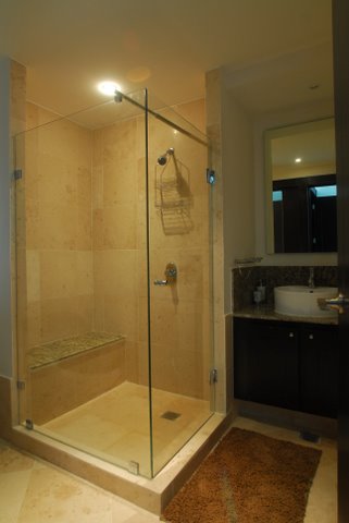 contemporary bath huge shower with frameless doors and fine porcelian tile