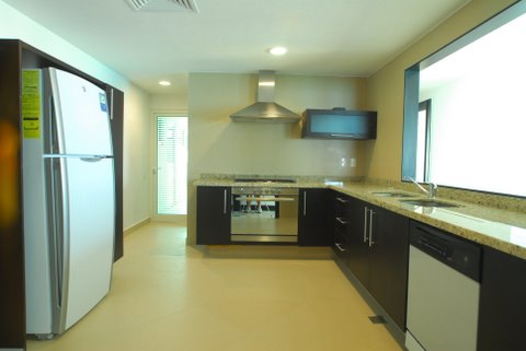 ultra luxury kitchen open to great room with granite counters, and fine porcelain tiles