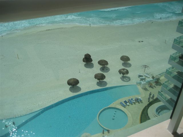 view of infinity pool, beach, and Caribbean ocean from the oceanfront patio