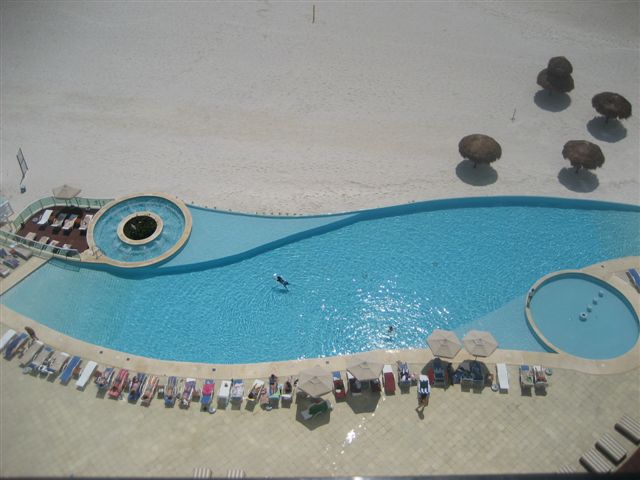 view of infinity pool, beach, and Caribbean ocean from the oceanfront patio