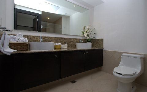 ultra luxury bathroom with sit down shower, granite towers, and fine porcelain tiles