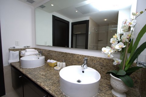 contemporary master bath with double basins, huge shower with frameless doors and fine porcelian tile
