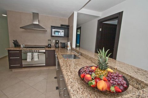 contemporary kitchen with open view to great room, and cancun ocean and beach