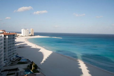 view of infinity pool, beach, and Caribbean ocean from the oceanfront patio