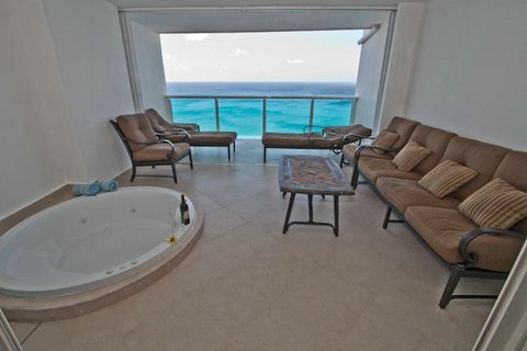 Relax on the luxurious patio furniture and feel the ocean breeze