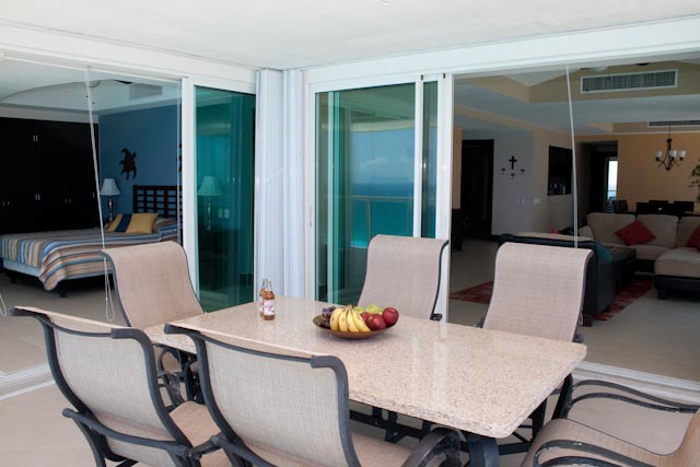 view of infinity pool, beach, and Caribbean ocean from the oceanfront patio