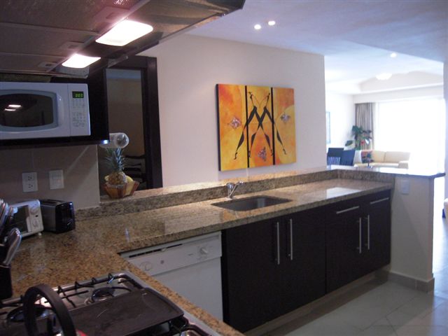 contemporary kitchen with open view to great room, and cancun ocean and beach