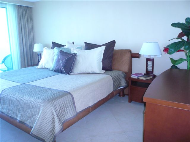 master bedroom with lagoon and city view terrace, full bath, walk in closet and 32 inch lcd tv