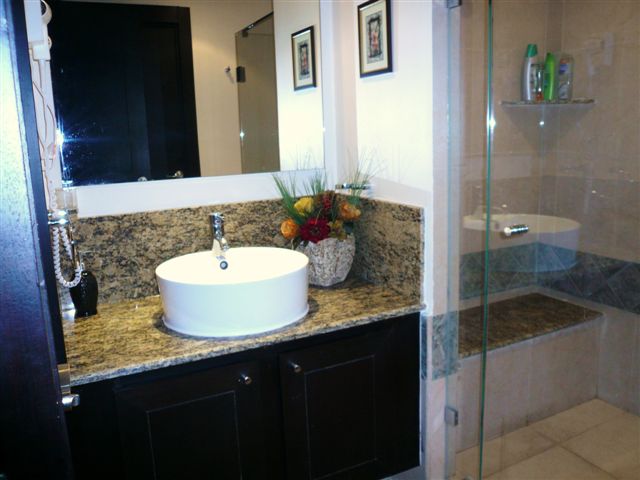 contemporary master bath with double basins, huge shower with frameless doors and fine porcelian tile