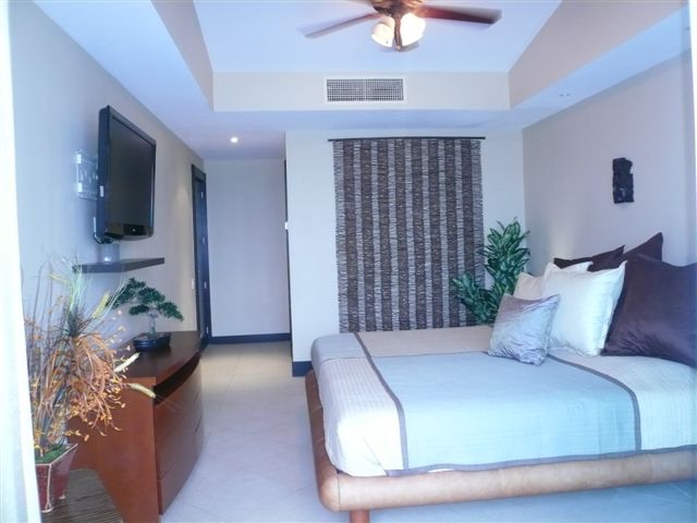 master bedroom with lagoon and city view terrace, full bath, walk in closet and 32 inch lcd tv