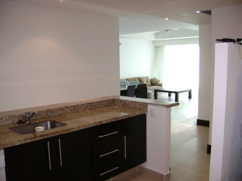 contemporary kitchen with open view to great room, and cancun ocean and beach